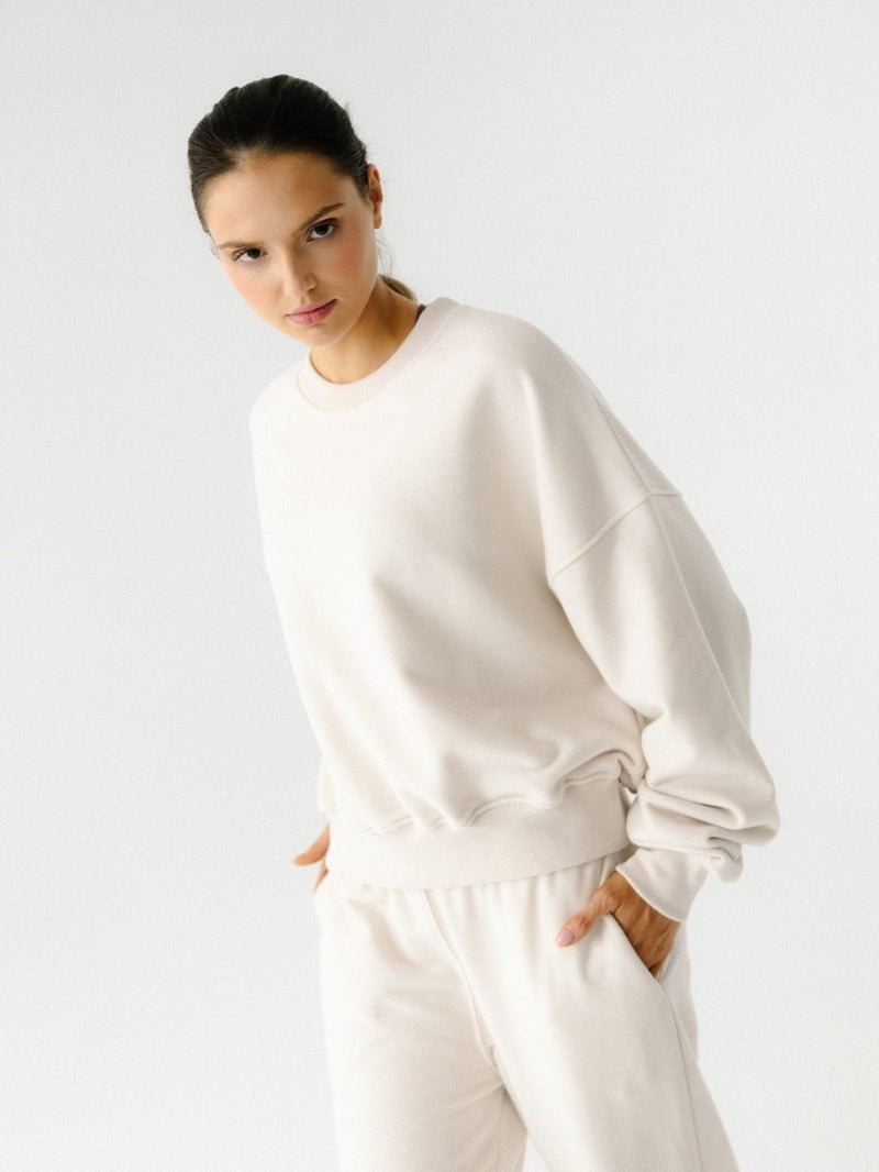 Szeroka damska bluza oversize w kremowym odcieniu z serii Spark